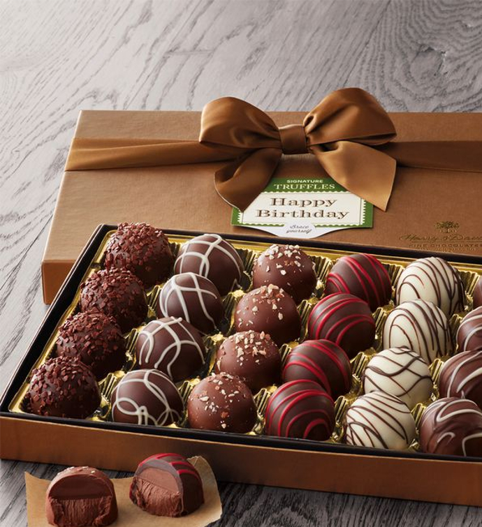 a box opened holding 20 choclate balls, each 4 of them has different flavor, the box cover has a ribbon and gift wrapped